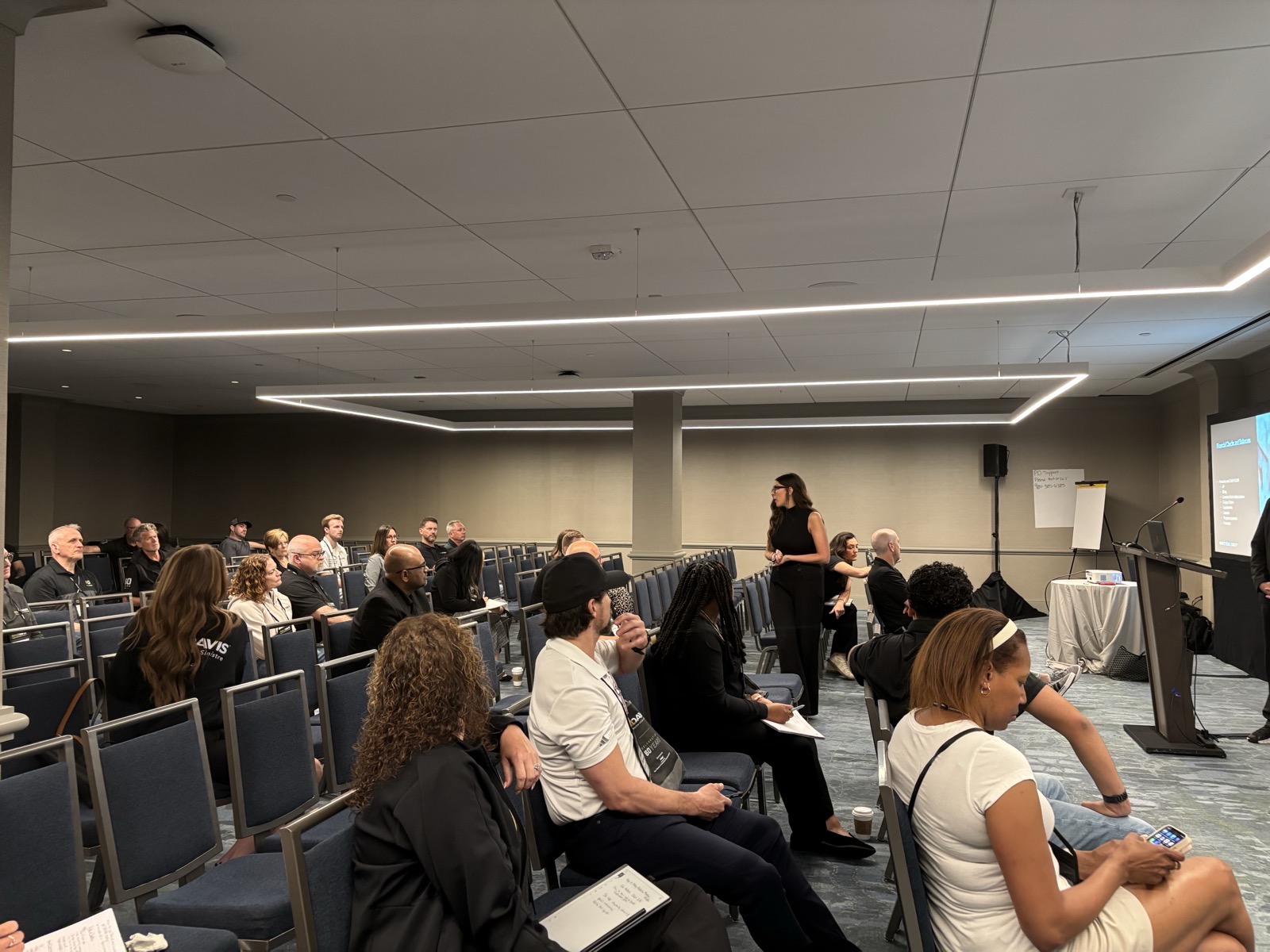 Kori Medeiros addressing a room at an industry event
